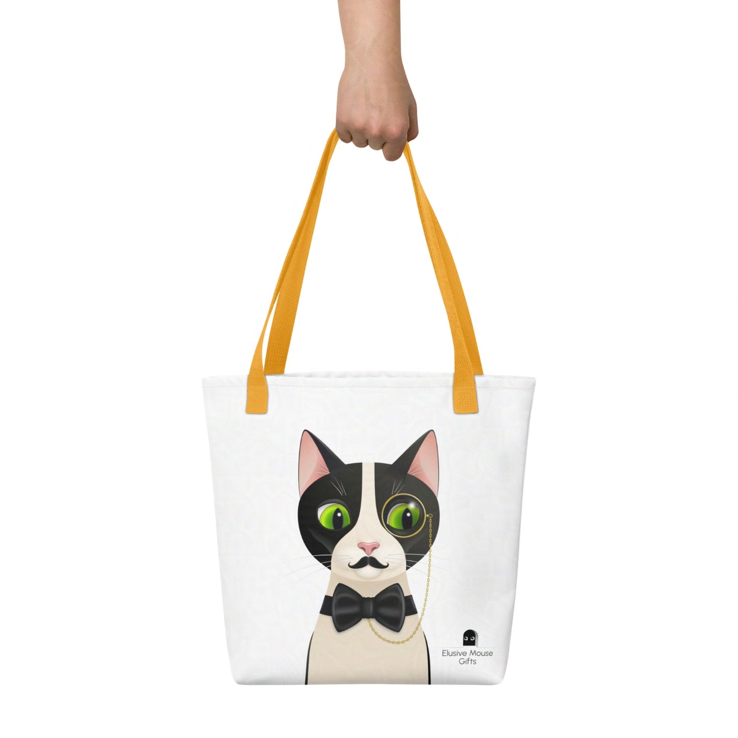 Alfred tote bag shown being carried by hand with the full cat illustration visible, against a white background