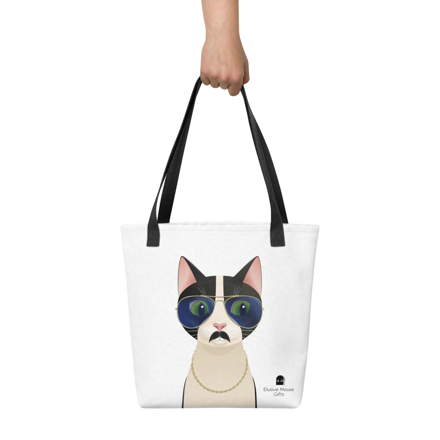 Freddie tote bag held by hand, showing the full playful cat illustration against a white background.