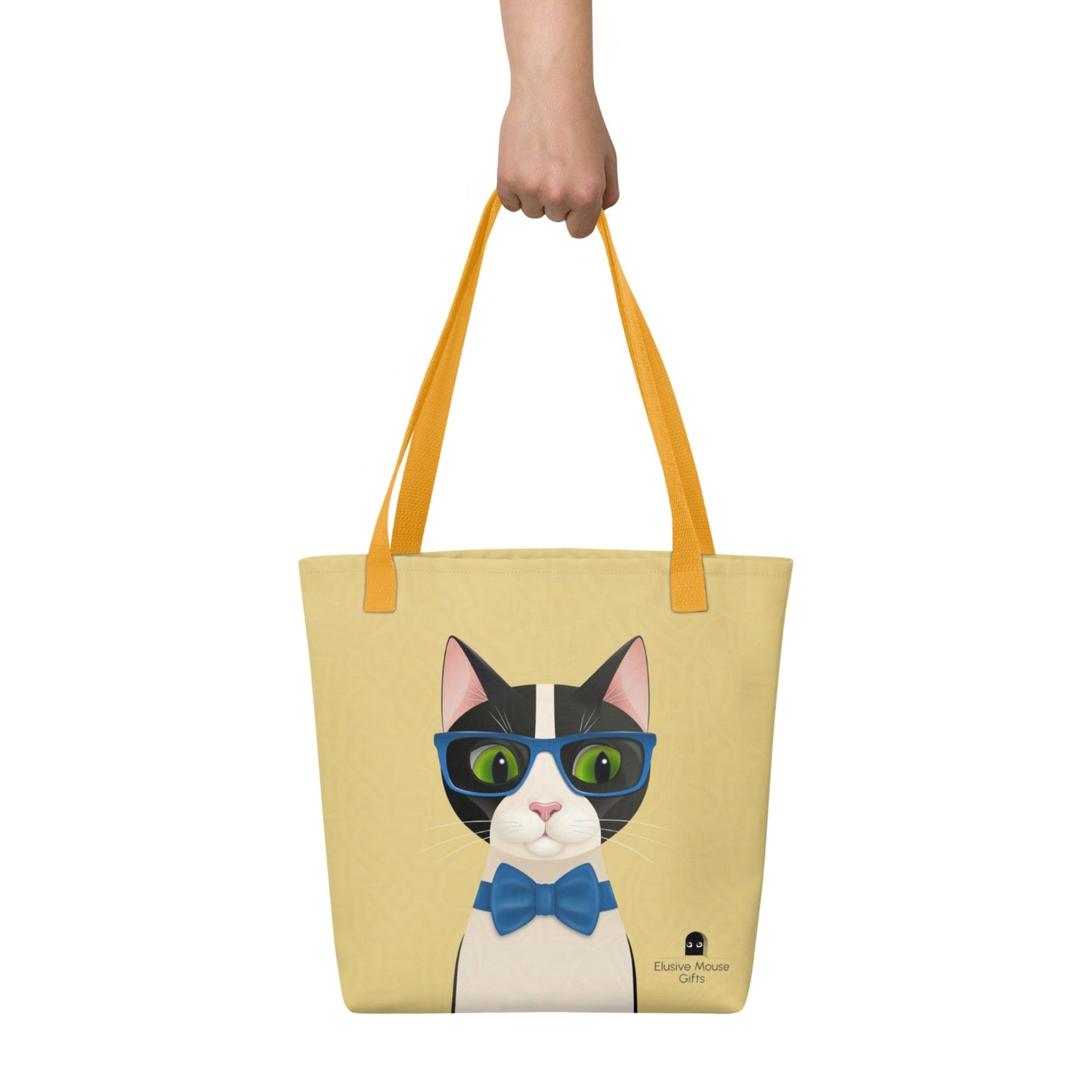Mr Cat tote bag being carried by hand, showing the full illustration clearly against a yellow background