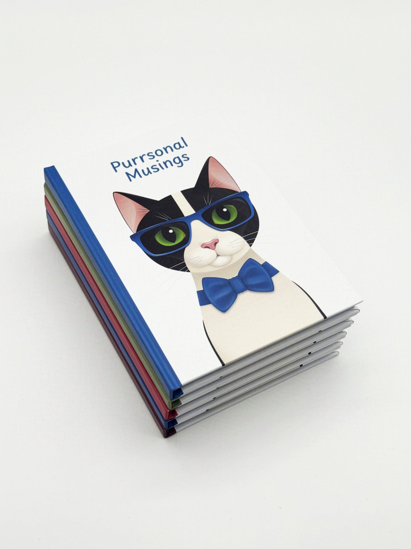 Stack of notebooks with an illustration of a cat wearing blue glasses and a bow tie and 'Purrsonal Musings' text on a white background