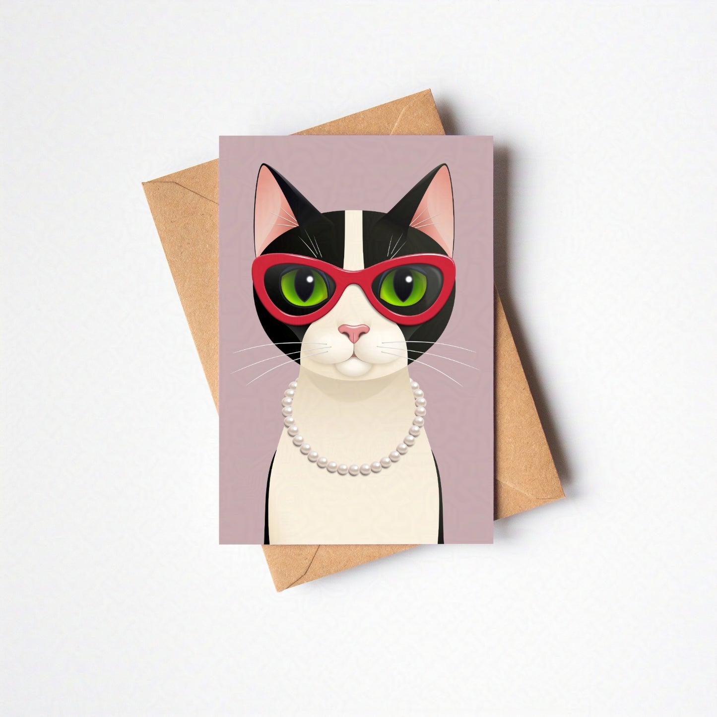Overhead view of Mrs Cat greeting card and envelope laid flat, featuring the cat against a pink-coloured card background on a neutral backdrop