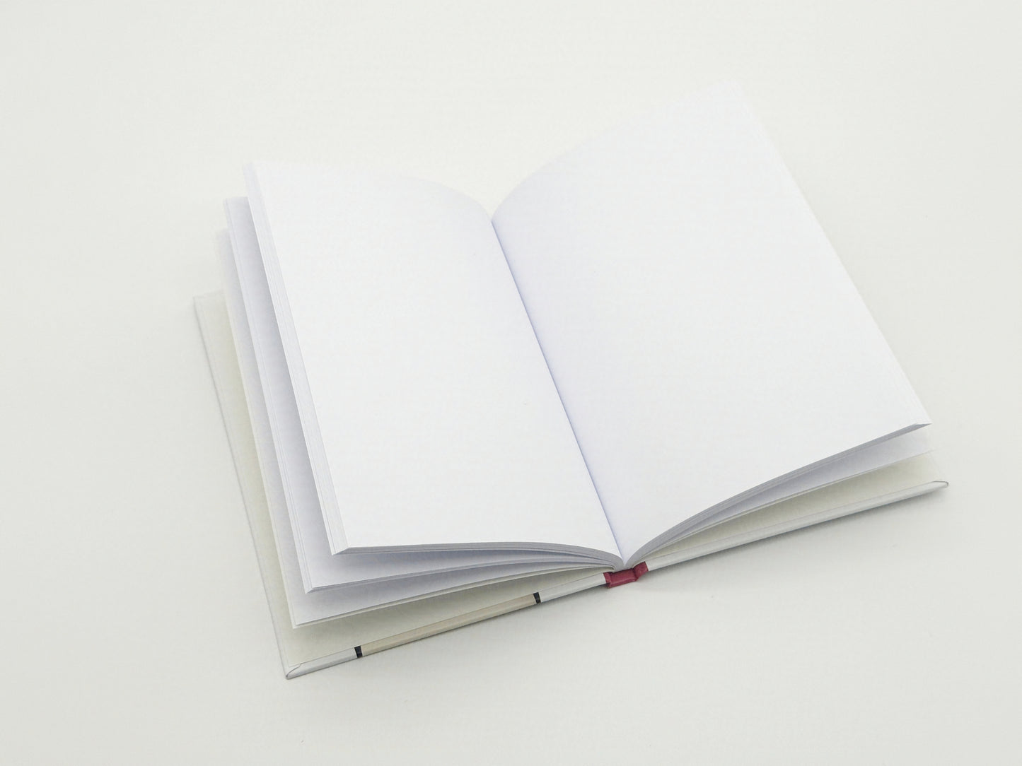 Open notebook with blank pages on a white background