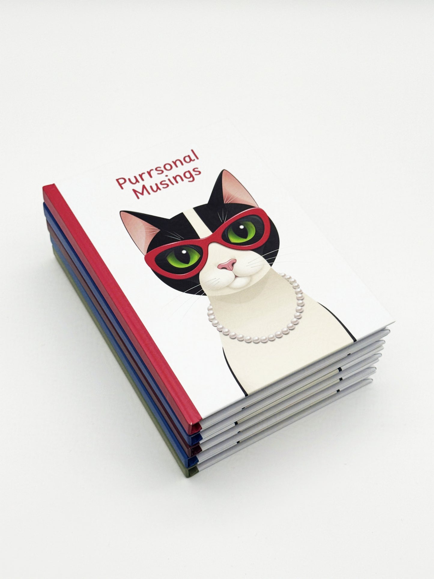 Stack of notebooks with a cat design and 'Purrsual Musings' text on a white background