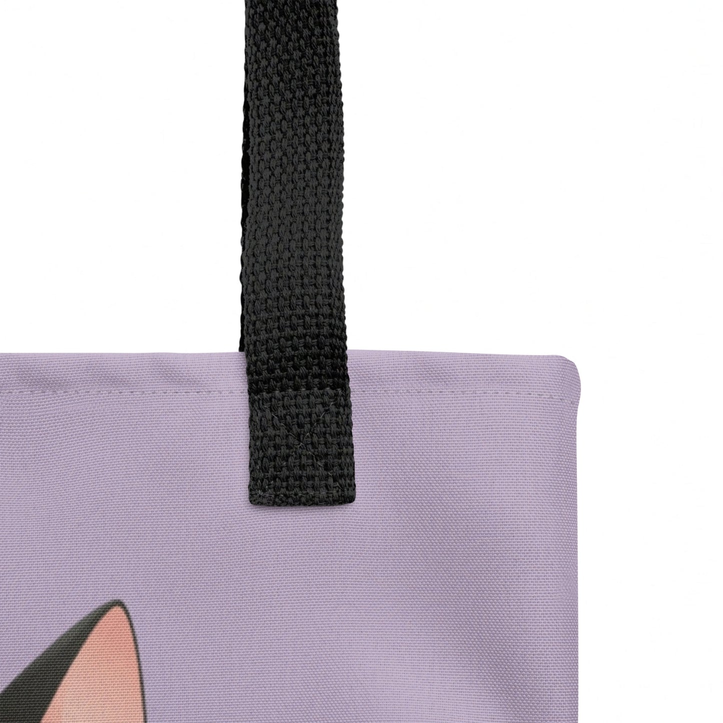 Close-up of tote bag strap join, highlighting sturdy stitching and the Smudge cat print against a lavender background
