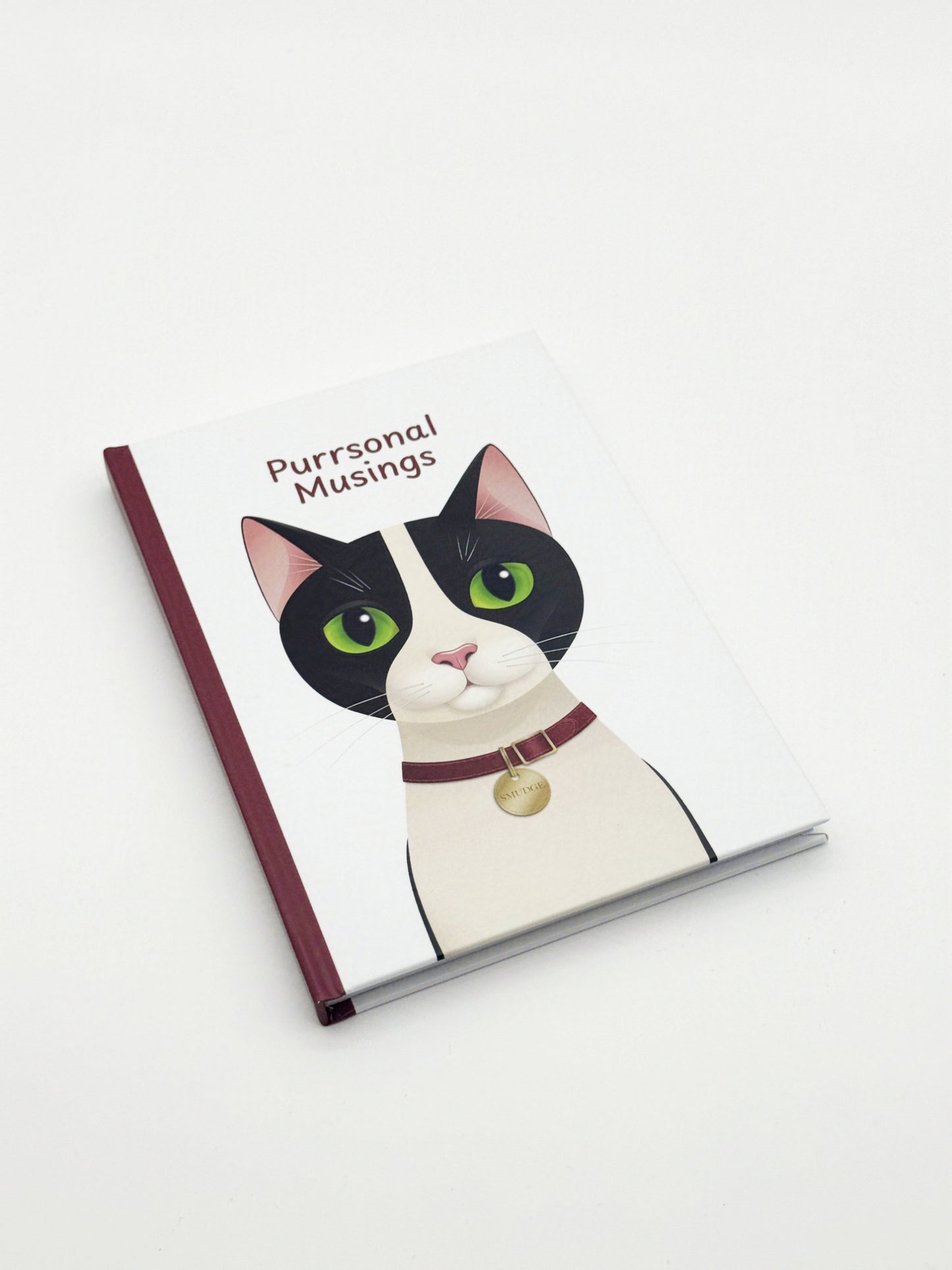 Notebook with a cat illustration and 'Purrsonal Musings' text on a white background