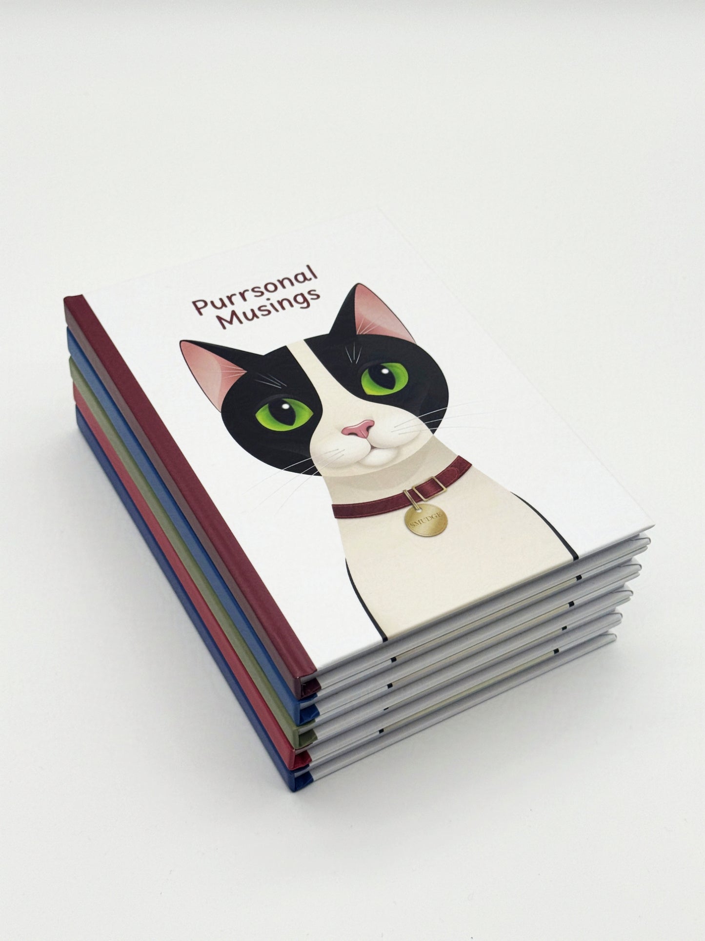 A stack of notebooks with a cat illustration on the top cover titled 'Purrsonal Musings' on a white background