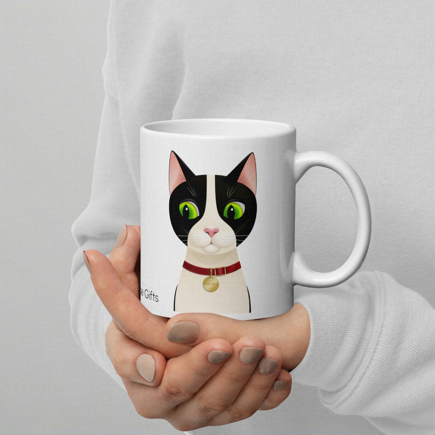 11oz Smudge mug held in hand, clearly showing scale and print size of the cat design