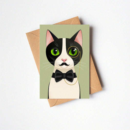 Overhead view of Alfred greeting card and envelope laid flat, featuring the cat against a sage green-coloured card background on a neutral backdrop