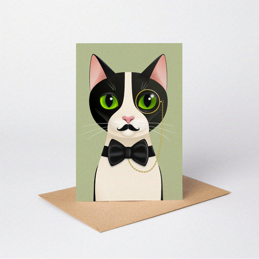Alfred Cat greeting card standing upright with the tuxedo cat against a sage green-coloured card background, on an envelope against a neutral backdrop