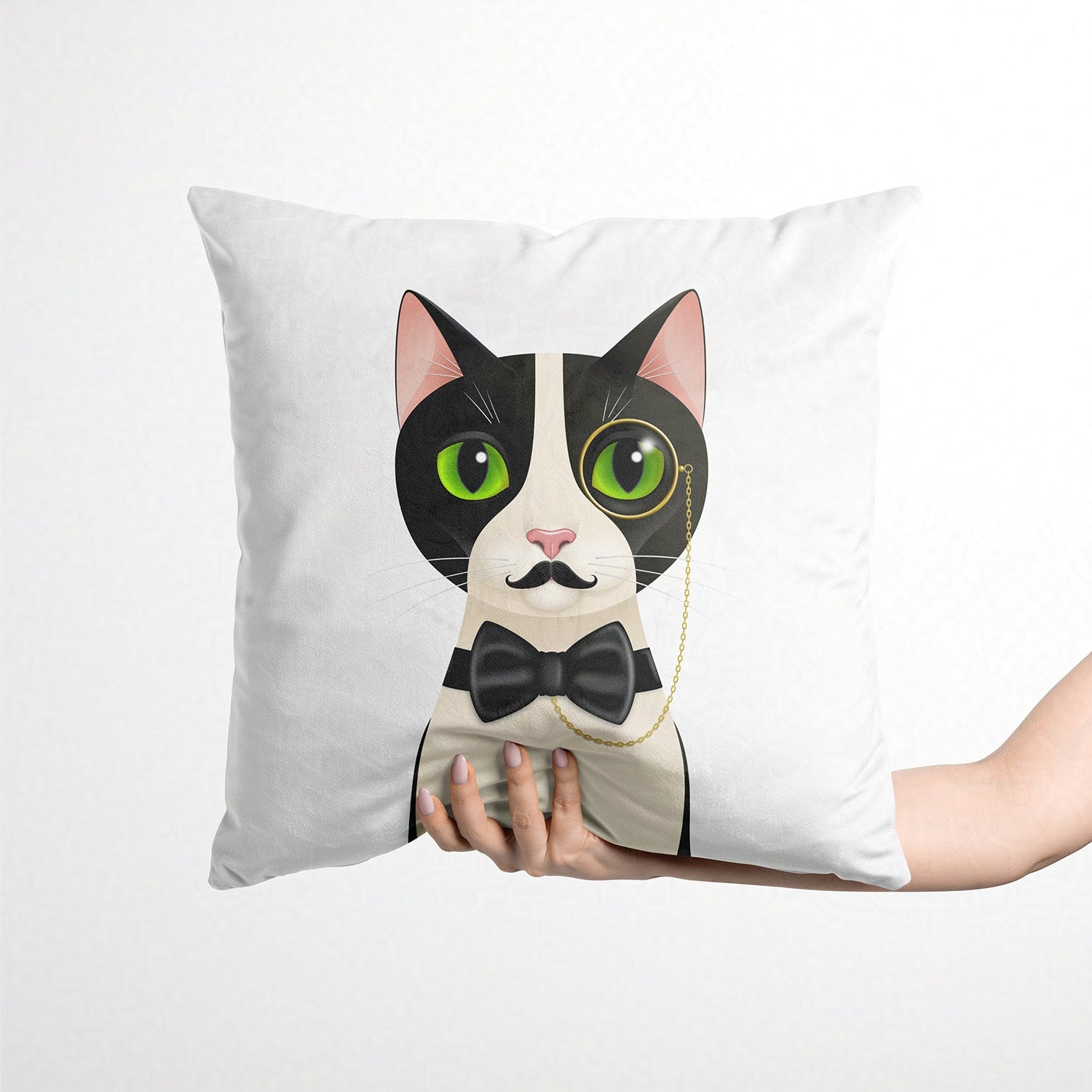 Cushion with a cat design featuring a bow tie held by a hand on a white background