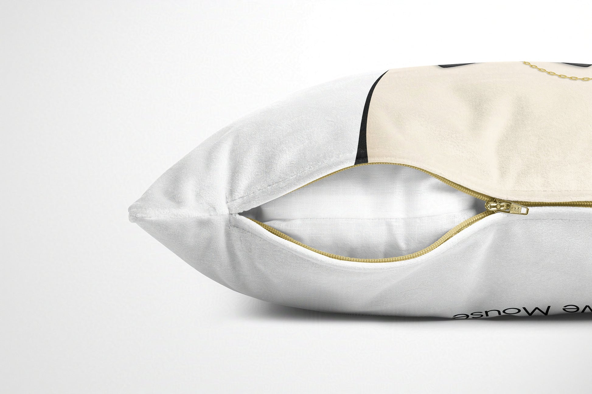 White cushion with gold zipper on a white background