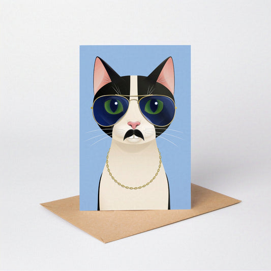 Mrs Cat greeting card standing upright with the tuxedo cat against a blue-coloured card background, on an envelope against a neutral backdrop