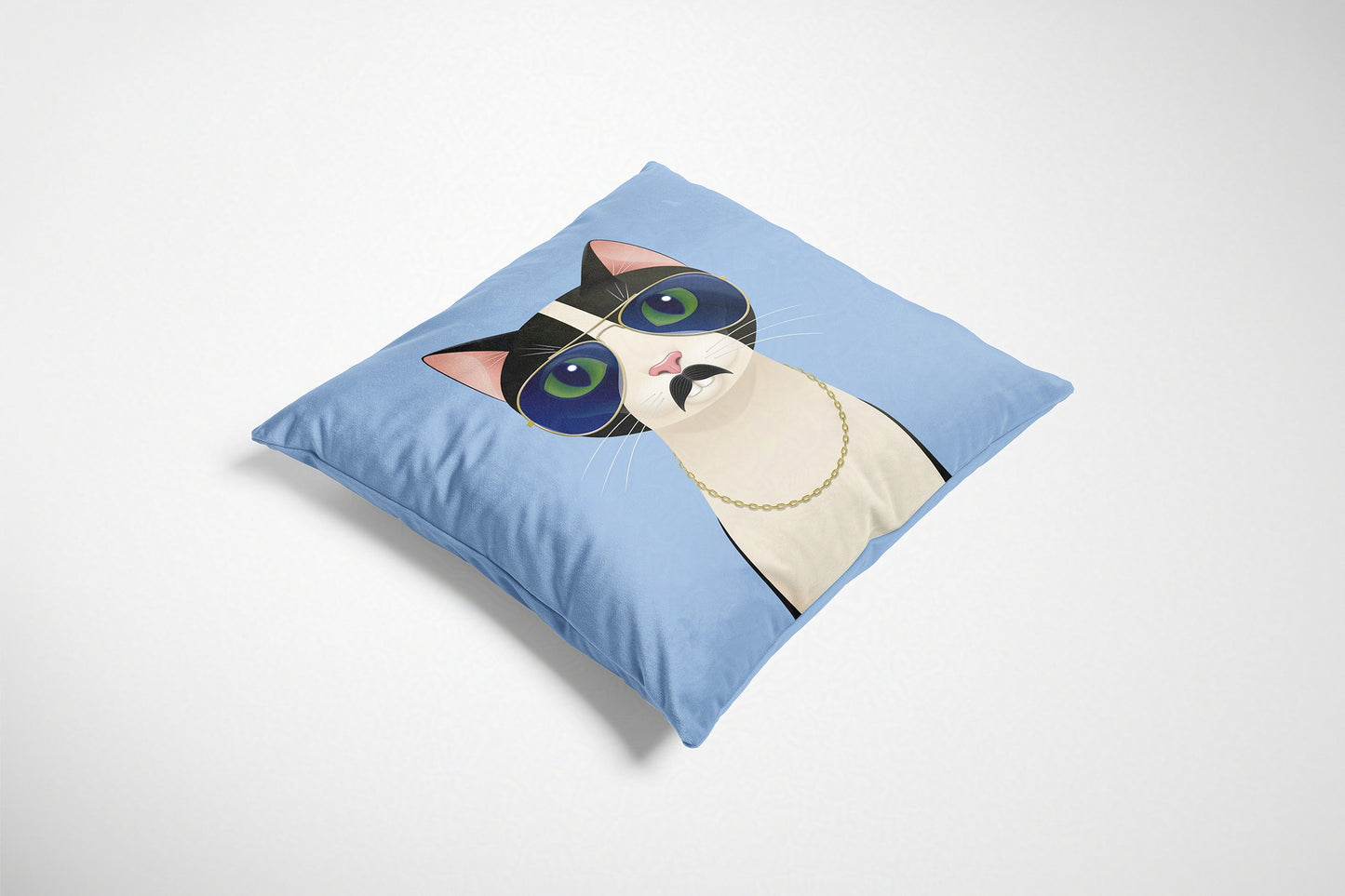 Blue decorative cushion with a cat design on a white background.