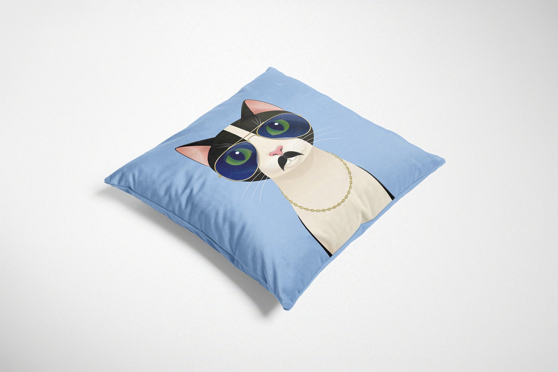 Blue decorative cushion with a cat design on a white background.