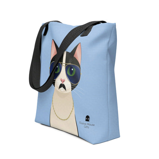 Tote bag with Freddie the tuxedo cat wearing aviator sunglasses, fake moustache, and gold chain, shown from a 3/4 angle on a blue background