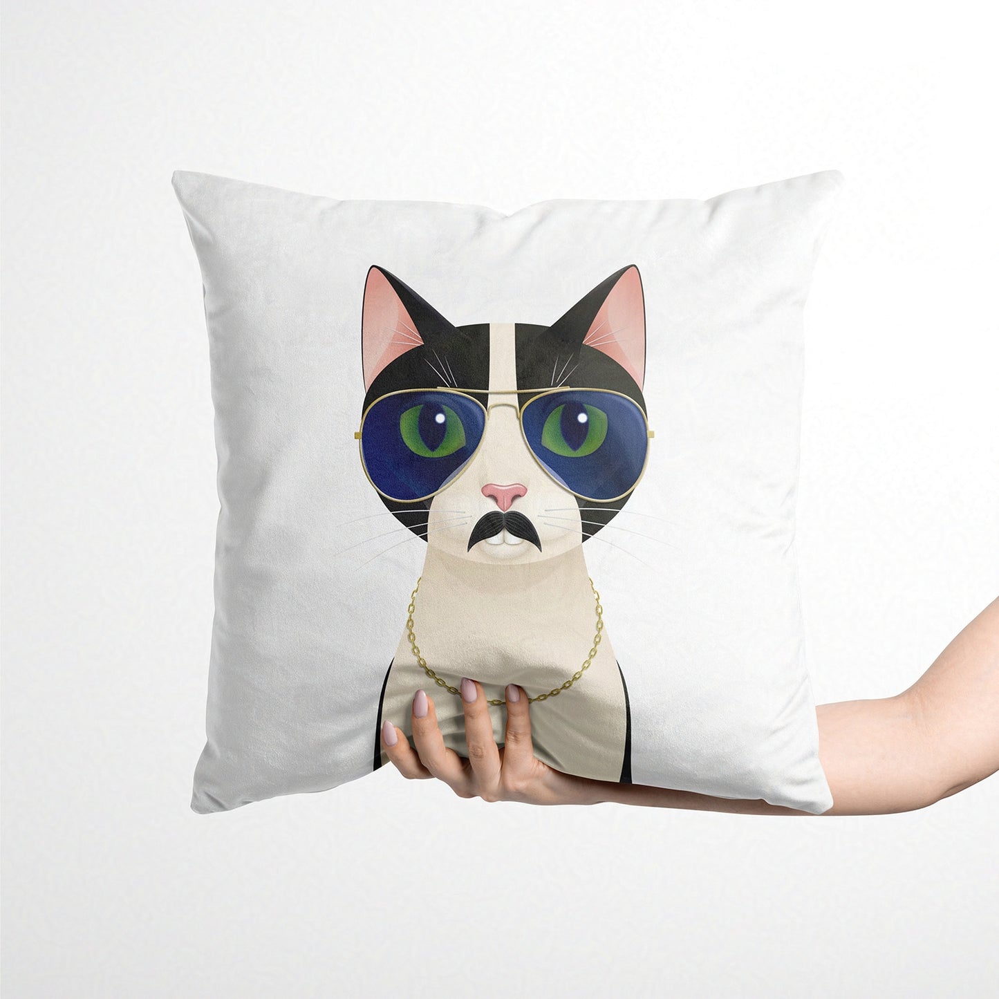 Cushion with a cat design wearing sunglasses and a moustache, held by a person against a white background