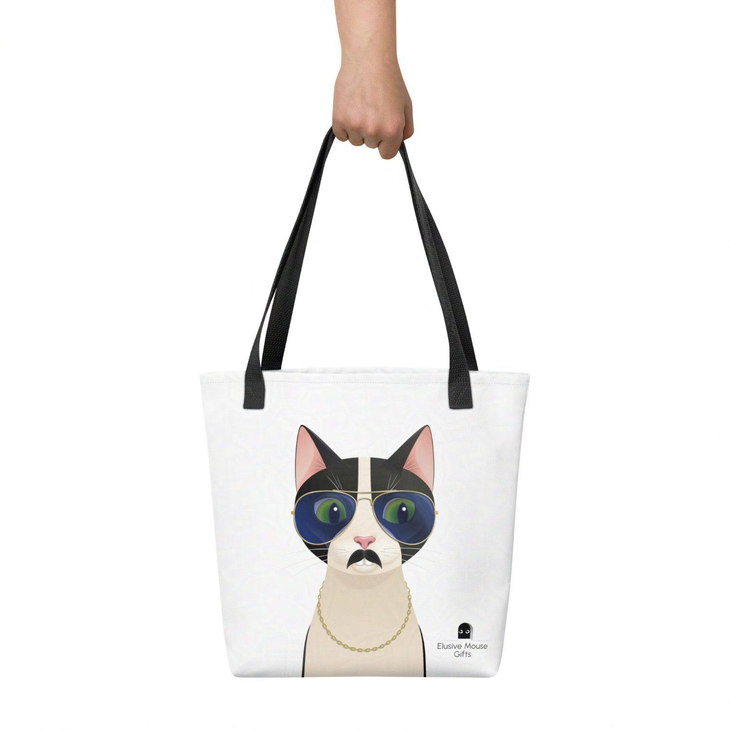 Freddie tote bag held by hand, showing the full playful cat illustration against a white background.