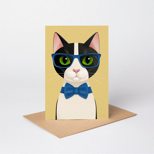 Mr Cat greeting card standing upright with the tuxedo cat against a yellow-coloured card background, on an envelope against a neutral backdrop