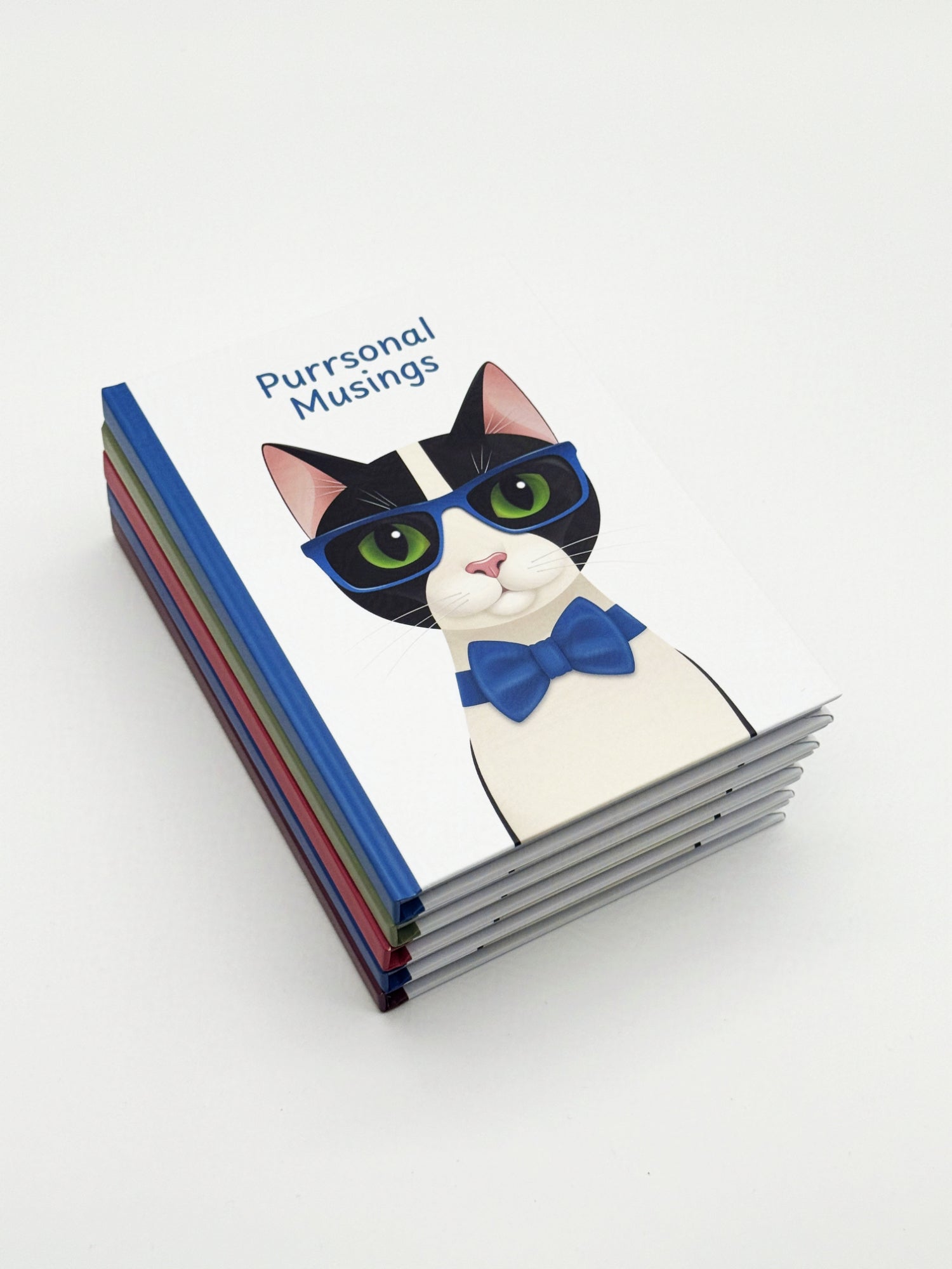 Stack of notebooks with an illustration of a cat wearing blue glasses and a bow tie and 'Purrsonal Musings' text on a white background