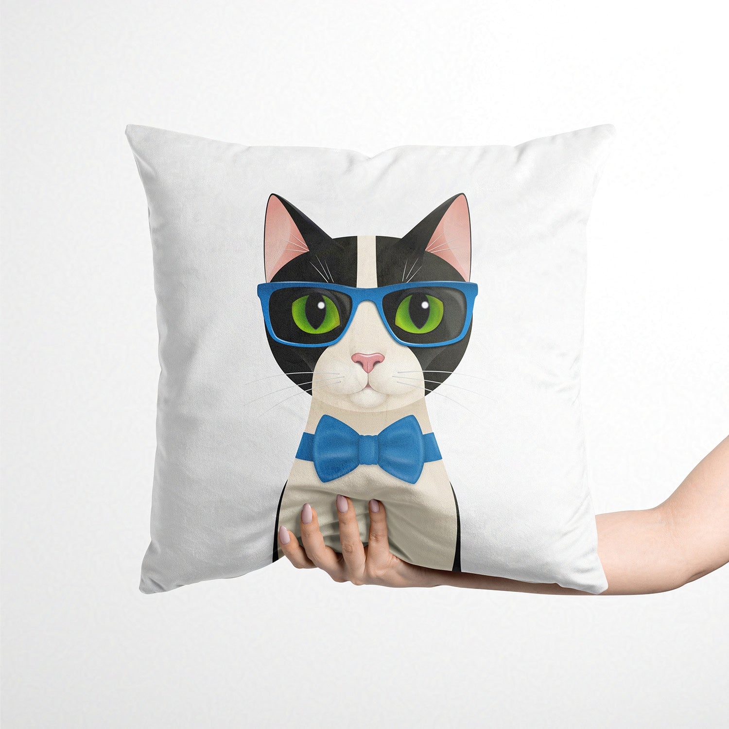 Cushion with a cat design wearing glasses and a bow tie, held by a person on a white background