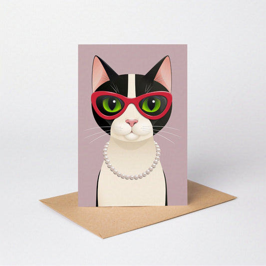 Mrs Cat greeting card standing upright with the tuxedo cat against a pink-coloured card background, on an envelope against a neutral backdrop