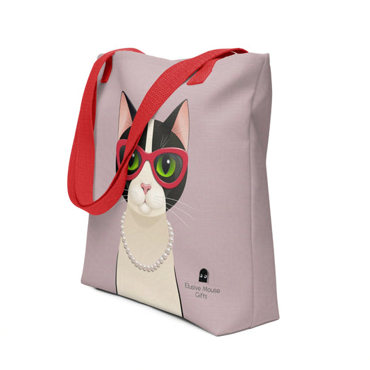 Tote bag featuring Mrs Cat in cat eye glasses and a pearl necklace, shown at a 3/4 angle against a pink background