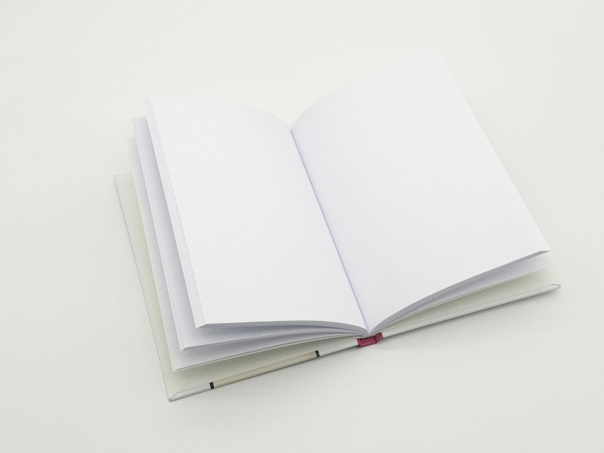 Open notebook with blank pages on a white background
