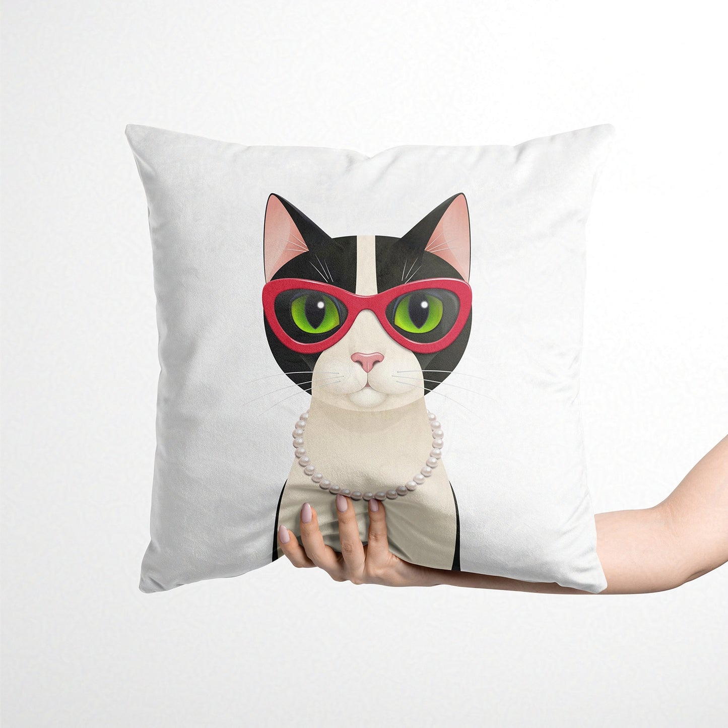 Cushion with a cat design wearing sunglasses held by a person on a white background