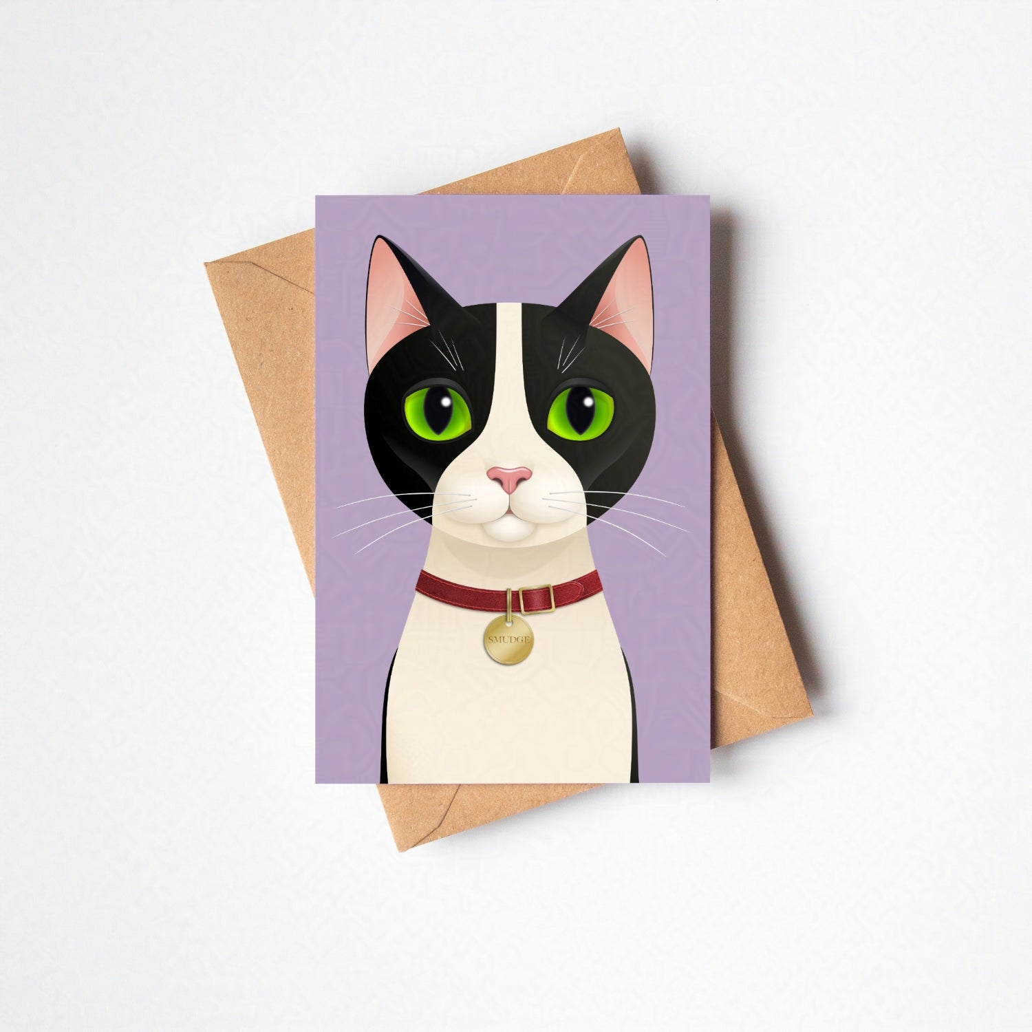 Overhead view of Smudge greeting card and envelope laid flat, featuring the cat against a lavender-coloured card background on a neutral backdrop