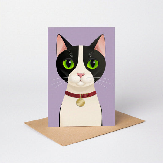 Smudge Cat greeting card standing upright with the tuxedo cat against a lavender-coloured card background, on an envelope against a neutral backdrop
