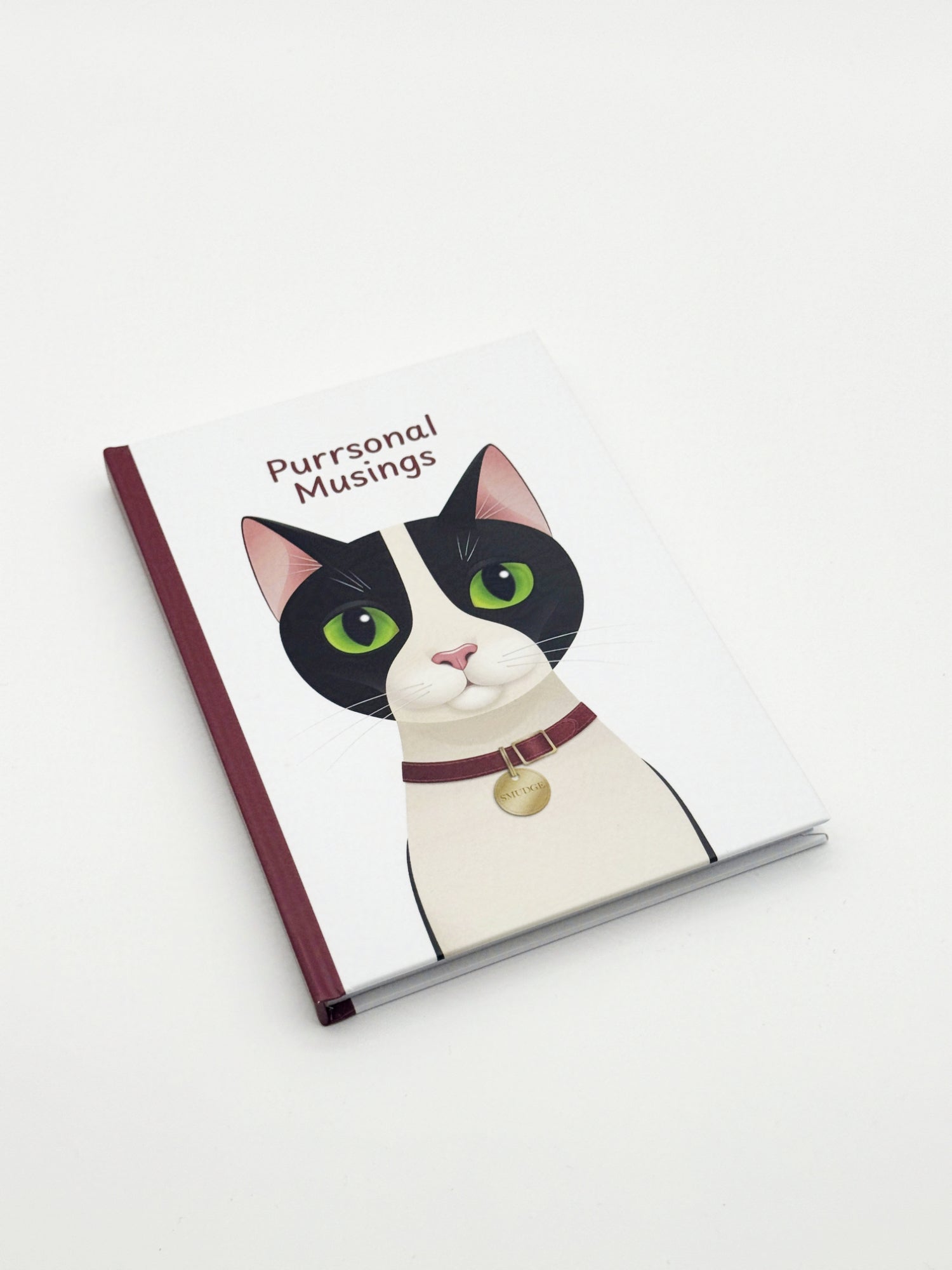 Notebook with a cat illustration and 'Purrsonal Musings' text on a white background