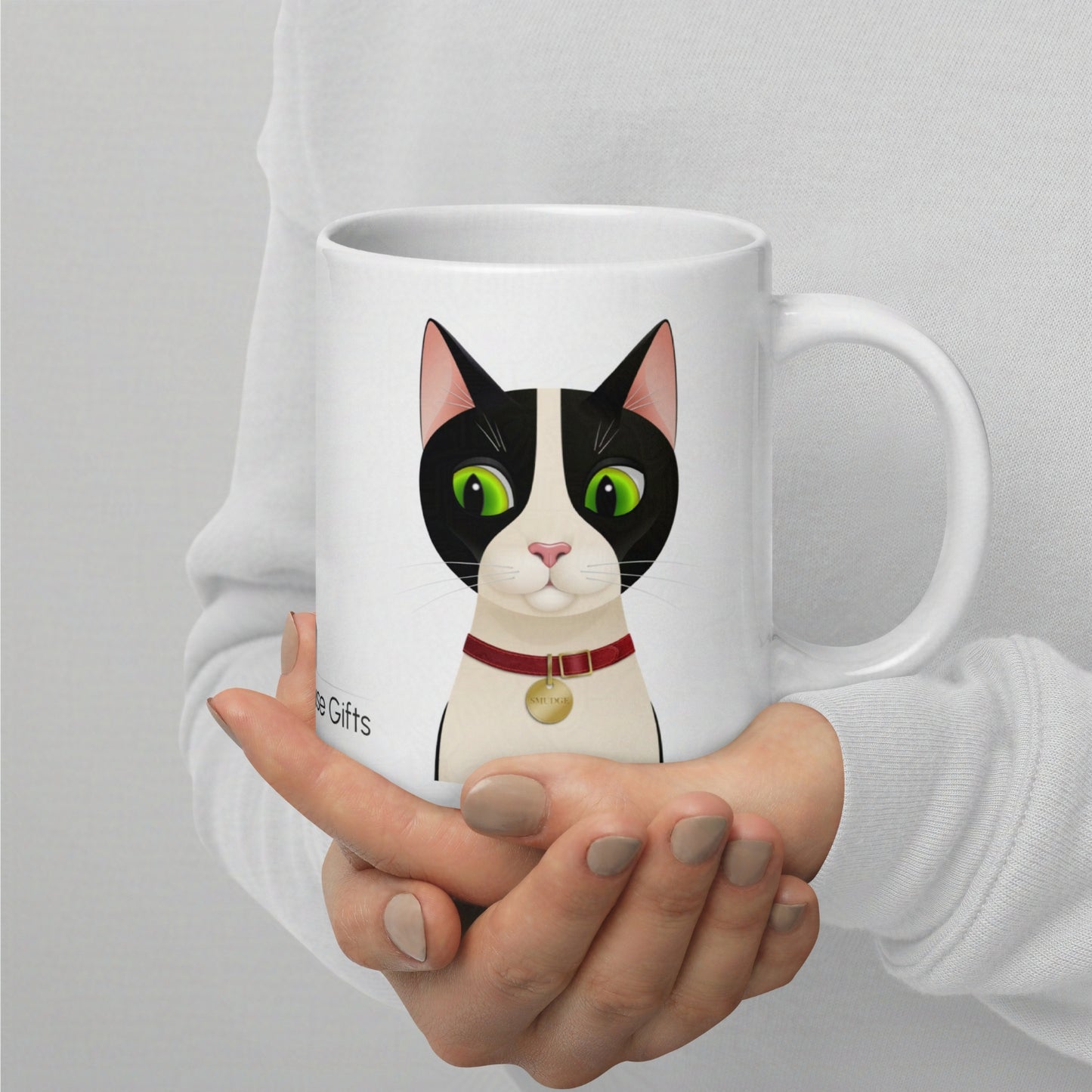 20oz Smudge mug held in hand, clearly showing scale and print size of the cat design