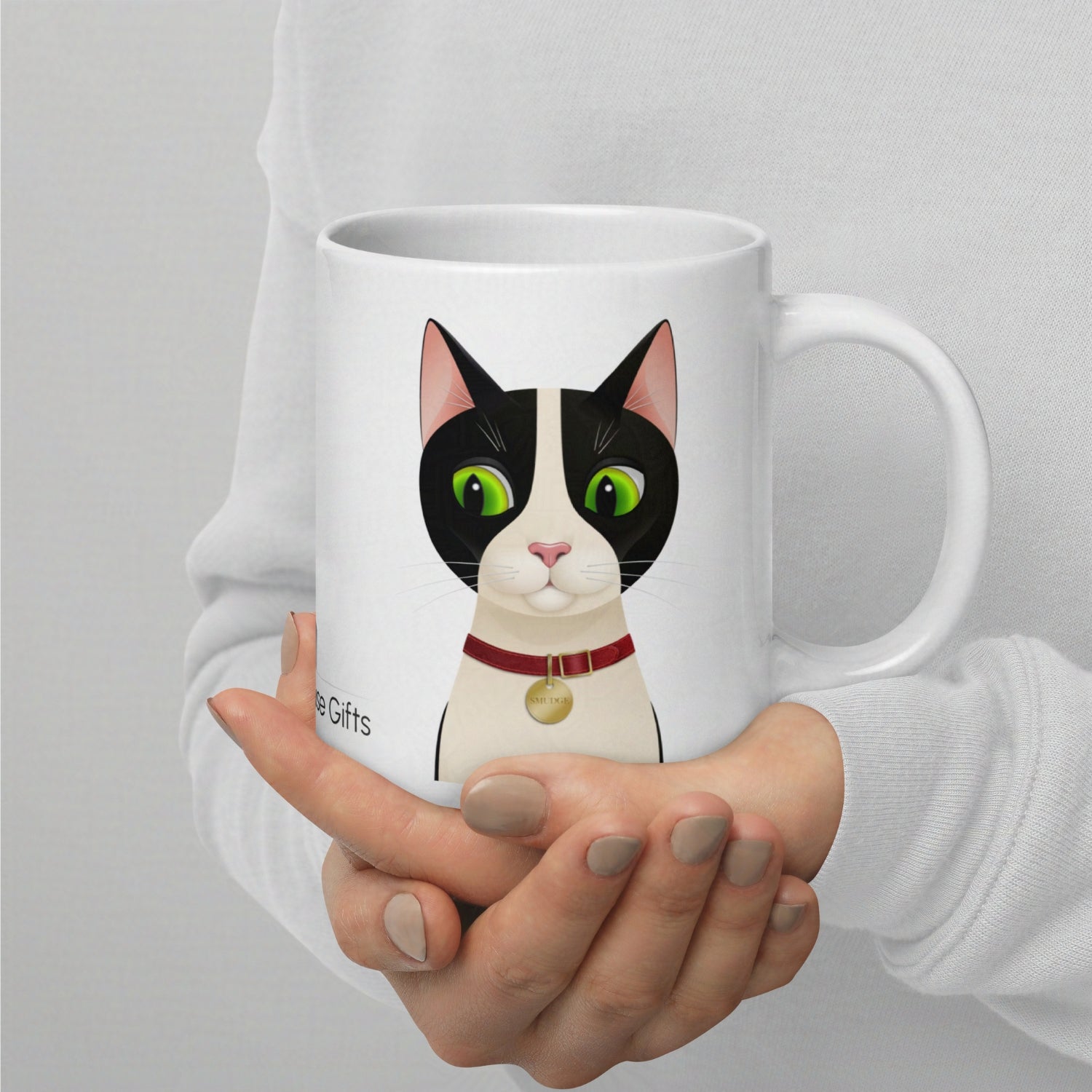 20oz Smudge mug held in hand, clearly showing scale and print size of the cat design